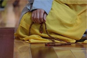 Munk Meditating With Mala Beads
