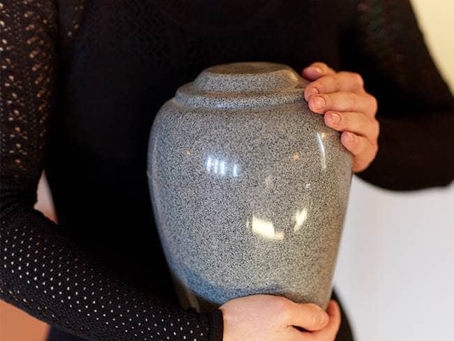 Person holding urn