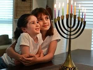 Children looking at a menorah