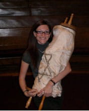 The author holding the Torah this past year at her father's synagogue