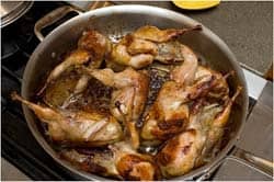 Quails browning in pan