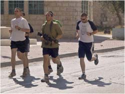 Settlers in Hebron find the need for protection, even on a run: Photo courtesy of Palfest via C.C. license at Flickr