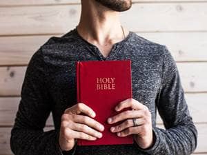 holding bible