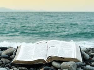 bible at ocean on rocks